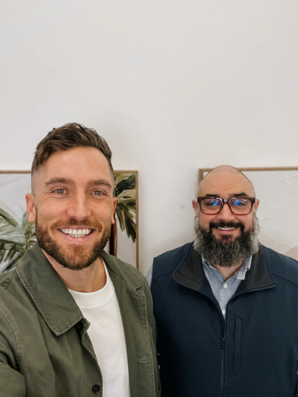 Andy Crebar and Nathaniel Cousin smiling together in a selfie at the office