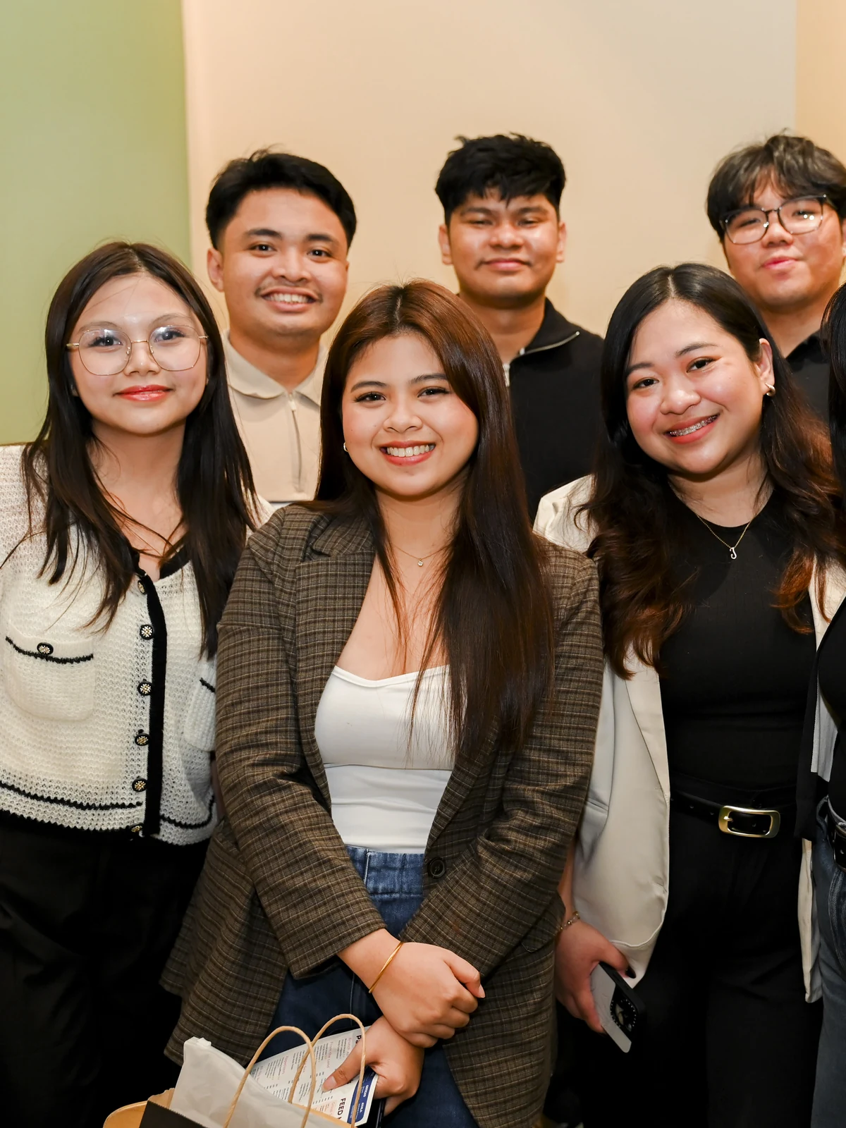 Members of the Wolf IQ Manila team grouped together, smiling at the camera